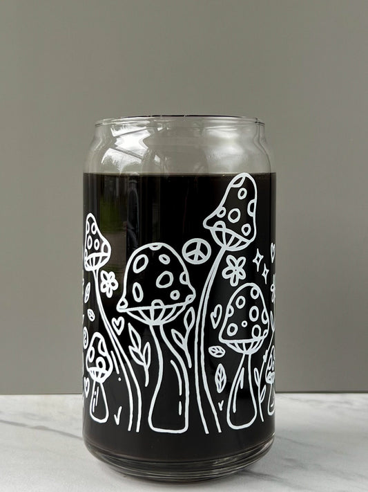 clear glass can with white mushroom illustrations on a gray background