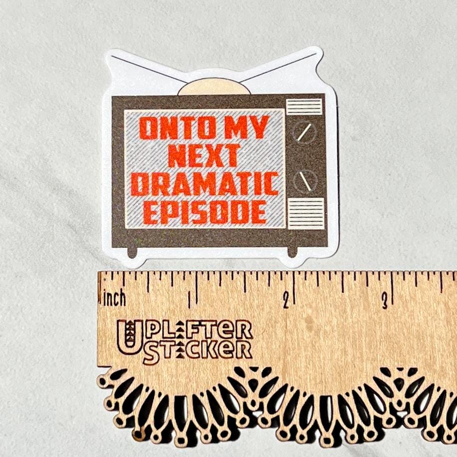 Sticker with 'Onto my next dramatic episode' text on a television screen design, next to a ruler for size reference.