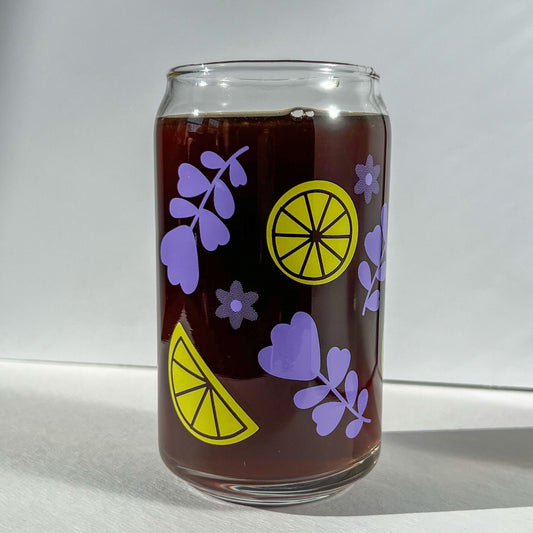 Clear glass can with purple lavender and yellow lemon slice designs on a white background