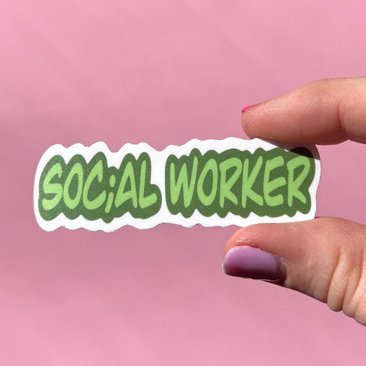 Hand holding a 'SOCIAL WORKER' sticker against a pink background