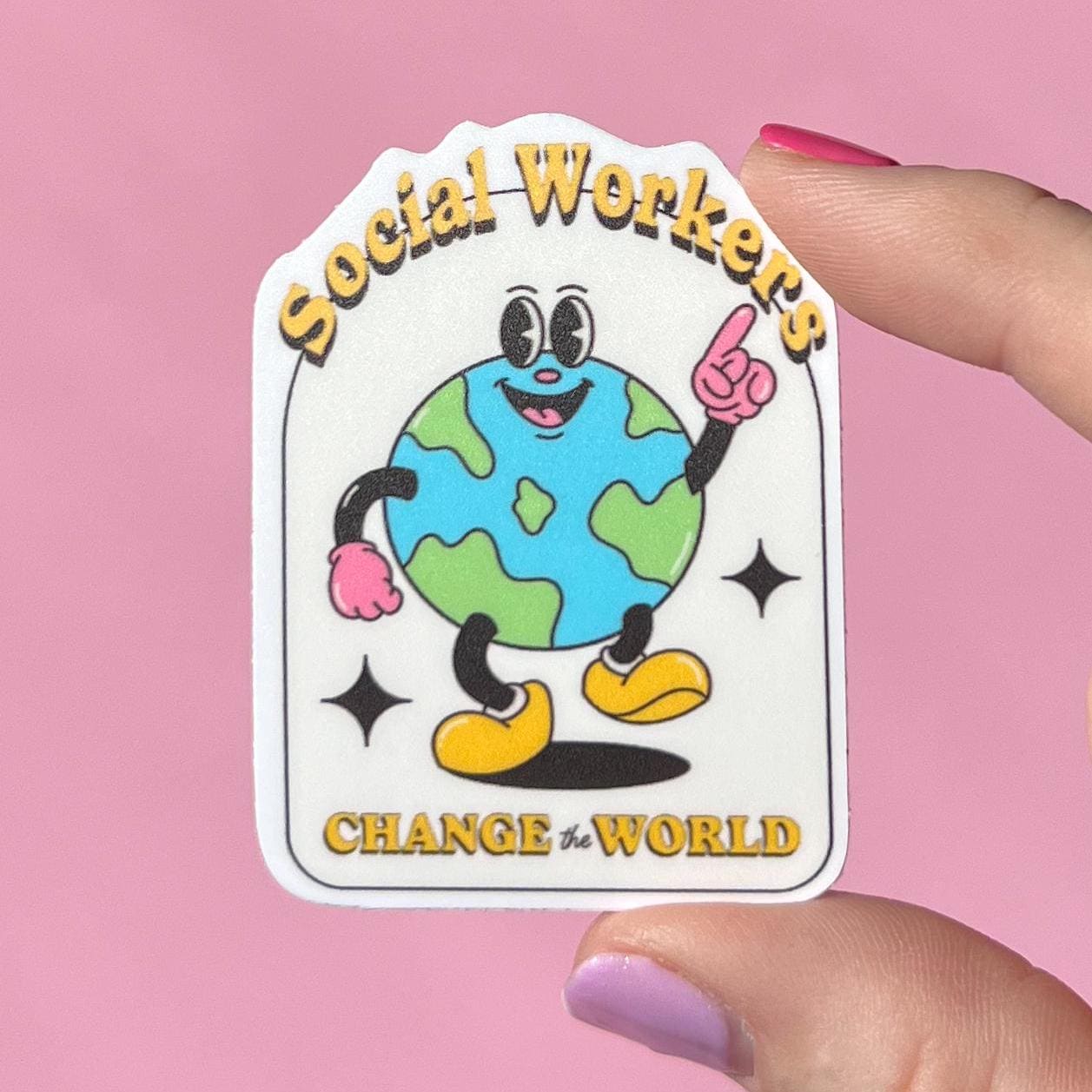 Sticker with cartoon Earth character and text 'Social Workers Change the World' held by a hand against a pink background