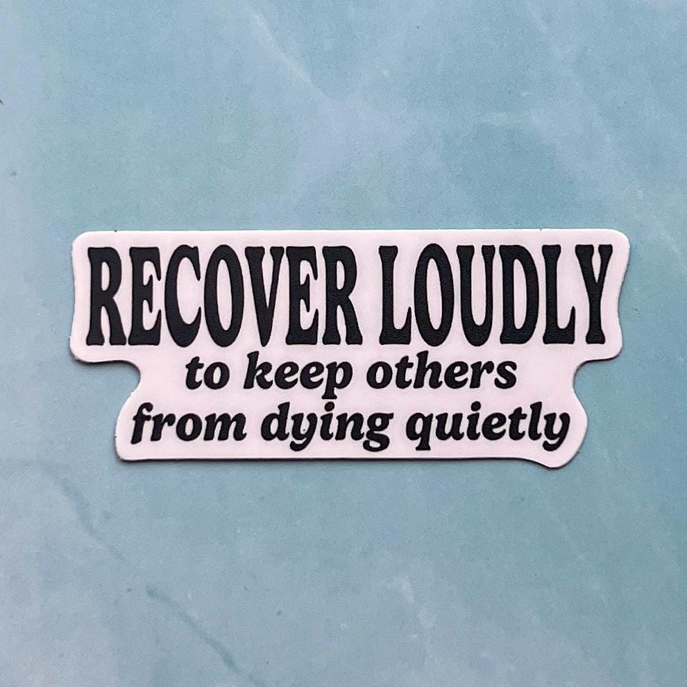 Sticker with text 'RECOVER LOUDLY to keep others from dying quietly' on a light blue background