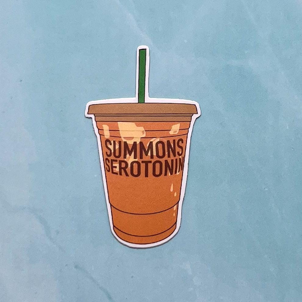 Illustrated sticker of a coffee cup with 'Summons Serotonin' text on a light blue background
